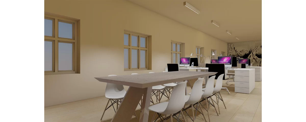 Visualización del área de trabajo con mesa de reuniones y estaciones de trabajo.